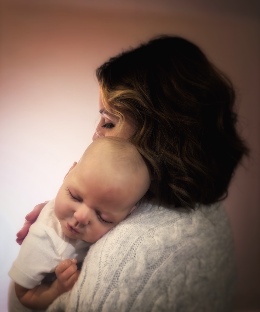 Photo of a beatiful reborn doll in her mum's arms